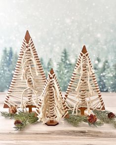 three wooden christmas trees on a table