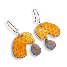 You'll feel gorgeous wearing these distinctive enamel polka dot earrings.  These statement earrings are lightweight, and are a standout mix of yellow, with orange polka dots, and a quirky light blue drop with a carved X.  They have high quality brass ear wires that clasp so you never have to worry about losing them!   What is enamel?   Enamel is made by fusing multiple layers of glass to a prepared metal at a very high heat.  Each earring requires between four to 10 layers of enamel depending on Orange Enamel Earrings For Gifts, Orange Enamel Earrings For Gift, Orange Enamel Earrings As A Gift, Hand Painted Yellow Enamel Earrings, Playful Handmade Enamel Jewelry, Orange Enamel Earrings Nickel Free, Nickel-free Orange Enamel Earrings, Artistic Enamel Dangle Earrings, Artsy Enamel Drop Earrings