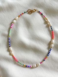 This multicolor freshwater pearl necklace is the perfect necklace for the daytime. It's unique in style and pattern. This necklace is 15 inches in length with an inch for adjustment. All jewelry comes with a Beaded by Sandy care card explaining the best ways to take care of your jewelry.  Designed and handmade just for you in the USA. Personal message from the owner of Beaded by Sandy: Hello! Thank you so much for the support and continuous love. I am a teenager from South Texas who loves making jewelry and creating art. I started my small business back in 2019. I have participated in local market events and have made Beaded by Sandy known in my small town. I am thankful for my followers, supporters, and family for the genuine love! Please message my Instagram for any questions.   IG: @bea