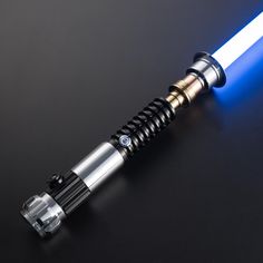 a blue light saber on a black surface