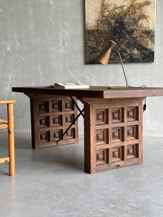 a wooden desk with a lamp on top of it