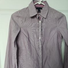 Tommy Hilfiger Ruffled Placket Striped Button Up Fitted Purple Shirt Blouse Size 2. Lightweight 100% Cotton Purple And White Striped Fabric. Collared Neck. Ruffle Detail Along Button Closure. Contrasting Velvet Ribbon Under Buttons. Fitted Button Down Shirt. Long Cuffed Sleeves. Rounded Hemline. See Photos For Measurements. New With Tags. Comes From Clean Pet And Smoke Free Home. Tommy Hilfiger Fitted Long Sleeve Shirt, Tommy Hilfiger Long Sleeve Work Shirt, Tommy Hilfiger Long Sleeve Shirt For Work, Tommy Hilfiger Classic Fitted Shirt, Fitted Classic Tommy Hilfiger Shirt, Tommy Hilfiger Classic Shirt For Work, Classic Fitted Tommy Hilfiger Shirt, Elegant White Tommy Hilfiger Tops, Classic Tommy Hilfiger Shirt For Work