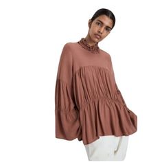 Elevate Your Wardrobe With This Zara Boho Tunic Blouse, Featuring Long Bell Sleeves And A Ruffle Neck. Made From High-Quality Materials In Turkey. Long Bell Sleeves Ruffle Neck Boho Style Made In Turkey Size L Mauve Color Bust Pit To Pit - 22” Length - 24” Features: Blouse Size: Womens L Condition: New Without Tags Chic Smocked Top With Lantern Sleeves For Spring, Chic Flowy Top With Ruffle Sleeves, Chic Fall Peasant Top With Lantern Sleeves, Chic Smocked Lantern Sleeve Top For Spring, Billowy Long Sleeve Peasant Top For Brunch, Chic Lantern Sleeve Peasant Top For Fall, Fall Brunch Blouse With Lantern Sleeves, Fall Brunch Lantern Sleeve Blouse, Viscose Long Sleeve Blouse For Layering