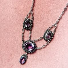 This Stunning Early Victorian (Est. Circa 1830) Amethyst Necklace Is A Gorgeous Addition To Any Collector’s Assortment Of Historic Jewelry. Although Unmarked, Our In House Jewelry Experts Estimate This Necklace Is Crafted In Sterling Silver In The Cannetille Style, Similar To Filigree. The Stones Are Amethyst And Measure Just Over 3/4” At Their Largest And 1/2” At Their Smallest Length. The Length Of The Necklace Itself Is 16” From The S Hook To The Silver Jump Ring. Sku: 00a0ev Historic Jewelry, Antique Jewelry Victorian, Medieval Necklace, Festoon Necklace, Jewelry Victorian, Medieval Jewelry, S Hook, Amethyst Necklace, Jump Rings