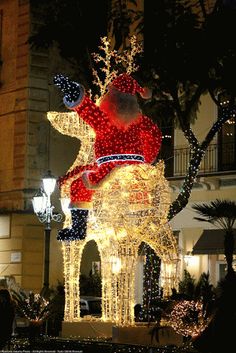 a large christmas light display in front of a building with lights and decorations on it