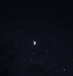 the night sky is full of stars and a half moon