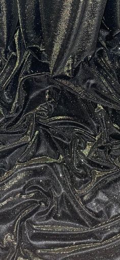 black fabric with gold sequins on the bottom and side, as well as other material