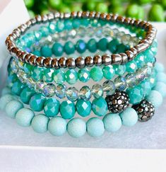 Set of 5 Bead Bracelets  Wear all together or individually  Available in Island Blue or Smokey Gray Size 18 cm Stretch Band to Fit Most Sizes  Arrives in Gift Box  Fast Shipping Blue Crystal Bracelet With Stackable Round Beads, Turquoise Stretch Bracelet With Stackable Round Beads, Turquoise Stackable Stretch Bracelet With Round Beads, Turquoise Stretch Bracelet With Round Beads, Turquoise Crystal Bracelet With Colorful Beads, Turquoise Stackable Beaded Bracelets With Round Beads, Turquoise Stretch Bracelet With Faceted Beads, Turquoise Beaded Stretch Bracelet With Round Beads, Turquoise Crystal Bracelet With Faceted Round Beads