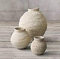 three vases sitting on top of a wooden floor