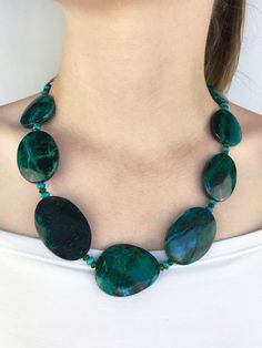 "If you like stunningly beautiful and one of a kind gemstone jewelry that makes a statement then you will love this Chrysocolla necklace with its bold and big oval free form nuggets along with the accents of the Green Chrome Diopside and the Turquoise rondelles that gives this handcrafted piece its powerful presence.  It's a \"piece de resistance\" that will transform any ensemble from \"meh\" to \"marvelous\"!  The big stones are so smooth and comforting to touch and wear....this is a \"one of a kind\" necklace....will NOT disappoint! AAA+ natural genuine semi precious flat organic smooth Chrysocolla free form oval nuggets from Peru (26.15 x 21.97 x 8.19mm - 48.14 x 31.58 x 8.13mm) with faceted natural genuine semi precious exotic/rare Chrome Diopside rondelles (4.5 - 4.72mm) and real nat Silver Statement Necklace, Green Chrome, Silver Necklace Statement, Kingman Turquoise, Creative Expressions, The Well, Peru, Crystal Healing, Semi Precious