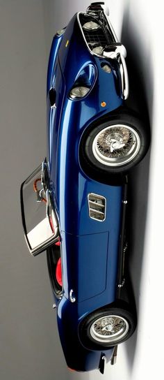 a blue sports car is hanging on the wall