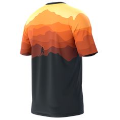 an orange and black shirt with the silhouette of a man running across a mountain range