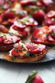 strawberries and cream cheese on toasted bread with fresh mint sprinkles