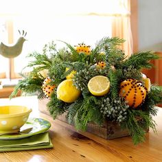 an image of a christmas centerpiece with lemons and greenery