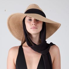 Sand toyo packable UPF 25+ protection wide-brim fedora with black chiffon pull-through scarf and 14K gold grommets. UPF 25+ protection Includes discreet adjustable grosgrain on inside crown for desired fit. From the Eugenia Kim Core Collection. 6" X 3.75" X 4.5" SKU: 21003-100CS Chic Visor Sun Hat For Travel, Elegant Sun Hat With Uv Protection For Travel, Elegant Fedora With Upf 50+ For Travel, Chic Visor Straw Hat With Uv Protection, Chic Straw Visor Hat With Uv Protection, Chic Travel Visor Hat, Chic Visor Sun Hat, One Size Fits Most, Chic Sun Hat Visor One Size Fits Most, Chic Visor Sun Hat One Size Fits Most