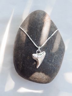 Often represented as symbols of strength, courage, and protection, a shark tooth can be a powerful amulet of individual expression. This silver shark tooth pendant necklace summons visions of prestige, strength, good fortune. Wear it proudly and invoke your power.✦ DETAILS ✦✧ Mano (mah NO) - shark.✧ Sterling silver shark tooth.✧ Sterling silver chain.✧ All Ke Aloha Jewelry pieces come packaged thoughtfully, beautifully, and ready for gift giving.✧ Unless otherwise noted in the listing description, all pieces are sold individually. Photos with models/multiple pieces are for style inspiration only. ✦ OTHER NECKLACES SOLD SEPARATELY ✦ Shark Teeth Jewelry, Shark Jewelry, Shark Tooth Pendant, Silver Shark, Tooth Pendant, Shark Necklace, Shark Tooth Necklace, Teeth Jewelry, Tooth Necklace