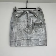 The Metallic Silver Skirt That Resembles A Biker Jacket. Front Exposed Zipper With Belt Loops At Hem. Two Front Zip Pockets With Two Zip Pockets At Back. See Pic For Natural Wearing On Material Slim Fit 92% Cotton, 6% Polyester, 2% Elastane Made In The Usa Fit Tip Fits True To Size. Fabric / Material 92% Cotton, 6% Polyester, 2% Elastane Silver Skirt, Leather Mini Skirt, Exposed Zipper, Leather Mini Skirts, Leather Mini, Biker Jacket, Fabric Material, Metallic Silver, Mini Skirt