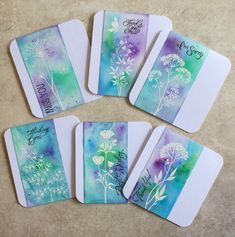 four cards with dandelions and the words happy birthday written on them are laid out next to each other