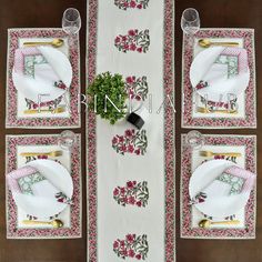 the table is set with white and pink placemats