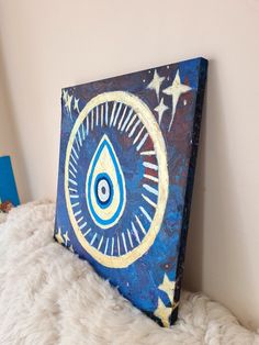 a blue and gold painting on a white wall