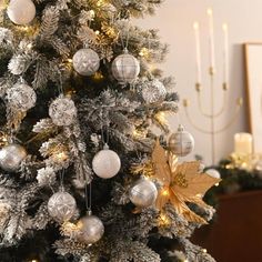 a decorated christmas tree with silver and gold ornaments