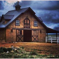 an old barn with a steeple on the roof