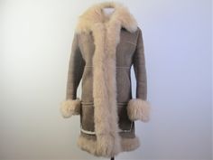 "Ready for a cold winter, here is a classic shearling \"Penny Lane\" style coat.  Made of genuine shearling with suede exterior, patch pockets, hook closures, clipped wool interior with long fuzzy shearling trim, the coat was most likely custom made as it doesn't have any labels.  It's in excellent condition without any stains or damage, only a tiny hint of exterior wear on the suede.  The size is a small.  I've included the measurements below allowing that the coat will go over other garments.  Bust 36\"-37\", Hips 41\", Length 35\", Sleeve length 22.5\", Back Shoulders (across shoulder blades) 14.75\"" Classic Sheepskin Fur Coat For Winter, Fitted Classic Sheepskin Fur Coat, Fitted Sheepskin Fur Coat, Fitted Shearling Fur Coat For Winter, Classic Long Sheepskin Fur Coat, Fitted Long Fur Coat For Cold Weather, Fitted Sheepskin Fur Coat For Winter, Fitted Long Sheepskin Coat, Fitted Sheepskin Long Coat