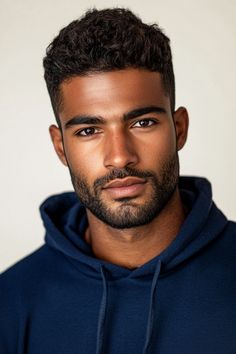 a close up of a person wearing a hoodie and looking at the camera with a serious look on his face