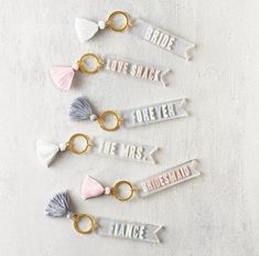 six keychains with tassels that say bride, love, break and be married