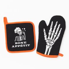 an oven mitt with a skeleton on it and a bone appetizer next to it