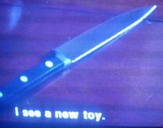 a knife that is sitting on top of a table with the words i see a new toy