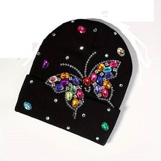 a black beanie with colorful jeweled butterflies on it's front and sides