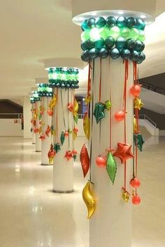 several christmas decorations are hanging on poles in the hallway