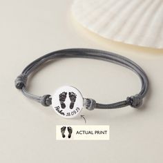 "This sweet and delicate bracelet can be personalized with the actual footprint or our sample print and name you provide us. It is perfect for Christmas, Anniversary, Birthday or Wedding gift. ► PRODUCT INFORMATION * Dics dimension: 3/4\" (19.5mm). * Word limits: 5-7 words/side on the back. * The whole charm is solid .925 Sterling silver with PU leather chain. You can choose to plate (coat) the items with yellow gold or rose gold, free of charge. * By default, silver items comes with BLACK engraving and gold-plated item comes with CLEAR engraving. ► HOW TO ORDER & ADD PERSONALIZATION - Include in the \"Add your personalization\" section the names, date or a short message you wish to have on each ring, separated with commas (which won't be included on the final product). - Add item to cart Silver Bracelets Keepsake For Mother's Day, Customizable Adjustable Charm Bracelet, Adjustable Bracelet For Mother's Day Keepsake, Personalized Round Bracelets For Keepsake, Personalized Adjustable Jewelry Keepsake, Personalized Adjustable Keepsake Jewelry, Adjustable Name Jewelry For Keepsake, Personalized Charm Bracelet For Father's Day Gift, Personalized Adjustable Charm Bracelet Gift