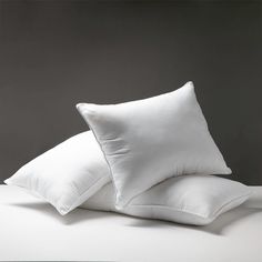 two white pillows sitting on top of each other