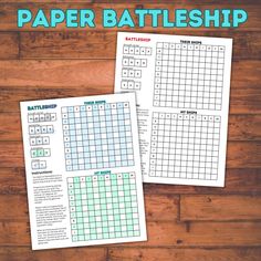 two printable paper battleships on a wooden table