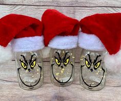 three glass slippers with santa hats on them