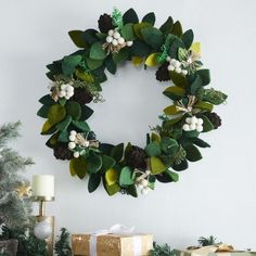 a christmas wreath is hanging on the wall next to presents and other holiday decor items