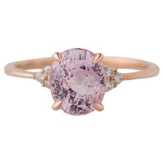 Discover timeless elegance with our enchanting GIA Certified 2.31 Carat Oval Pink-Purple Sapphire Diamond Cluster Ring, exquisitely set in 14k rose gold. The centerpiece features a captivating purplish pink sapphire, naturally unheated, measuring 8.21x6.83x5.12mm, radiating elegance and charm. Nestled between six clustered diamonds, each weighing 0.09 carats and measuring 1.4mm, the sapphire is framed in brilliance and sparkle. An exquisite choice for an engagement ring, available in size 6 with Luxury Pink Oval Sapphire Ring, Luxury Pink Oval Diamond Ring, Luxury 14k Rose Gold Oval Rings, Oval Morganite Ring In Pink Gold, Elegant Pink Sapphire Ring In 14k Gold, Oval Morganite Rings In Pink Gold, Pink Gold Morganite Oval Ring, Classic Pink 14k Rose Gold Jewelry, Luxury Pink Solitaire Ring