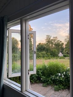 an open window looking out onto a field