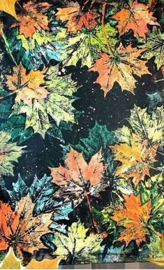 an image of autumn leaves on a black and green background with oranges, yellows, and reds