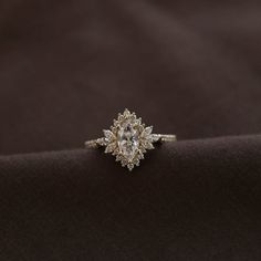 a diamond ring sitting on top of a black cloth