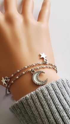 "Moon and Star Bracelet Beautiful Celestial theme bracelet with double strand White Enamel and Silver chain.  More about the bracelet: ~ double strand chain  ~ single closure fish hook clasp ~ decked with star charms, and rhinestone encrusted, white enamel moon Chain: ~ Stainless steel with White Enamel plating ~ We include a +1-inch extension chain in this bracelet. This feature allows you to adjust the length of your chain to your preference, ensuring you can wear it at the length that suits y Celestial Silver Bracelet With Star Charm, Silver Celestial Bracelet With Star Charm, White Star-shaped Metal Jewelry, Celestial Silver Charm Bracelet, Celestial Style Silver Metal Bracelets, Celestial Silver Metal Bracelets, Silver Bracelet With Star Charm For Party, Silver Star Charm Bracelets For Party, Silver Star Charm Bracelet For Party