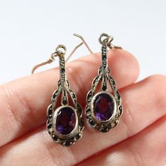 ~Length: 1&1/2 inch ~Amethyst size: 3/8 x 1/4 inch ~Marked 925 Ornate Purple Pierced Earrings, Ornate Purple Sterling Silver Earrings, Ornate Purple Jewelry With Matching Earrings, Ornate Sterling Silver Purple Jewelry, Ornate Purple Sterling Silver Jewelry, Ornate Purple Drop Earrings, Purple Stamped 925 Earrings For Anniversary, Antique Purple Sterling Silver Jewelry, Antique Sterling Silver Purple Jewelry