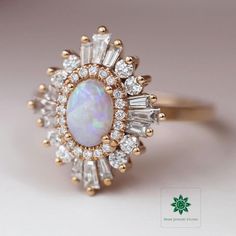 ♦ Main Stone: Ethiopian Opal ♦ Size: 1.25 CT (8x6 mm) ♦ Cut: Oval Cut ♦ Shape: Oval ♦ Color: White with Colored Flakes ♦ Ring Metal: 925 Silver/Gold ♦ Side Stones: Round & Tapered Baguette Cut ♦ Side Stones: 0.55 CTTW Approx.  ♦ Nickle Free ♦ Free Shipping to the United States ✥ O T H E R ∙ I N F O R M A T I O N ✥ ♦ Due to every item in our shop is made to order we are open for moderate customization on demand. Contact us prior to the order. ♦ Your item will be nicely packed to gift in elegant jewelry boxes. ♦ Some pictures show the listed engagement ring with various bands just to show how versatile it looks when paired with them, but they are not included with the Ring if it is not mentioned in the item description. ♦ The jewelry Certificate will be sent separately if demanded prior to t Gatsby Ring, Heidi Gibson, Halo Ring, Yellow Gold Ring, Elegant Jewelry, Opal Gemstone, Solid Yellow, Opal Rings, Yellow Gold Rings