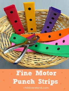 a basket filled with lots of different colored paper strips and scissors next to each other