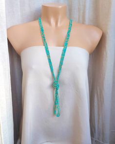 "Long turquoise necklace, boho tassel beaded necklace, v necklace. The knot is adjustable, simple to undo and redo at the height you would like! Or you can wear the necklace double up without any knot! It is a very versatile necklace that can be adapted to your taste.   ❤ PROCESSING AND SHIPPING Most orders are made and shipped out in one business day. Please check delivery timeframes for your location on the description below.  ❤ CUSTOM ORDERS If you like this item in a different color, send me a message indicating: color, size and quantity needed. I will send you a link for a \"custom order\" and you'll be able to place the order there.  If you like this item with some variations such as thickness or style, please also send me a message and I will work with you! Go back to my shop: https Turquoise Bohemian Tassel Necklace, Adjustable Turquoise Tassel Necklaces, Turquoise Lariat Beaded Necklace For Festival, Turquoise Beaded Necklaces With Tassels For Gift, Turquoise Necklaces With Tassel And Round Beads, Turquoise Necklace With Tassels And Round Beads, Turquoise Beaded Necklace With Tassels And Round Beads, Turquoise Beaded Necklace With Tassels, Adjustable Turquoise Tassel Necklace With Round Beads