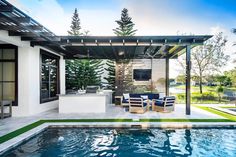 an outdoor living area next to a swimming pool