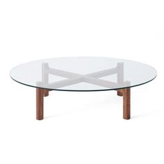 an oval glass table with wooden legs and a wood frame around the top, on a white background