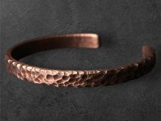 Description: 🌟 Unleash your bold style with our Hammered Solid Copper Metal Bracelet! A stunning blend of rustic charm and Viking-inspired craftsmanship, this unisex cuff bangle is a statement piece for both men and women. 🌟 ✨ Features: Handcrafted Hammered Design: Each bracelet is individually hammered by hand, giving it a unique texture that reflects an authentic, raw look. The rustic, worn-in style adds character and depth to this bold cuff bangle. Solid Copper Construction: Made from pure Adjustable Rustic Bangle Cuff Bracelet, Rustic Adjustable Bangle Cuff Bracelet, Adjustable Rustic Bronze Bracelets, Rustic Adjustable Bronze Bracelets, Rustic Adjustable Bronze Bracelet, Metal Art Jewelry, Edgy Accessories, Copper Cuff Bracelet, The Bangles